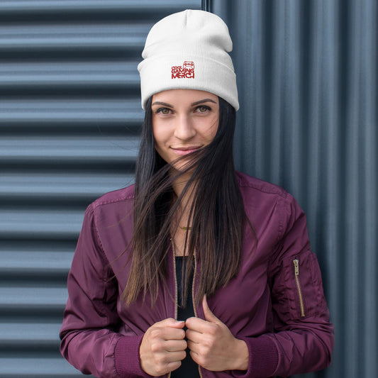 Woman wearing white beanie hat with cool gaming merch logo