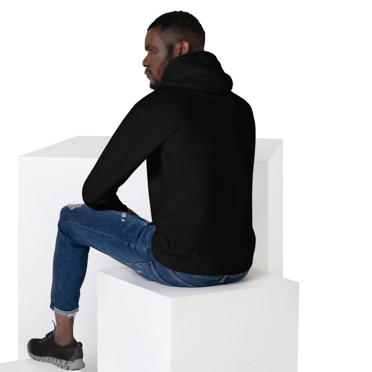 Man in black hoodie, sitting away from camera